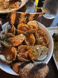 Lost Isle signature dishes Hearth Roasted Oysters, Grilled Fish, The Burger, Crispy Rice
